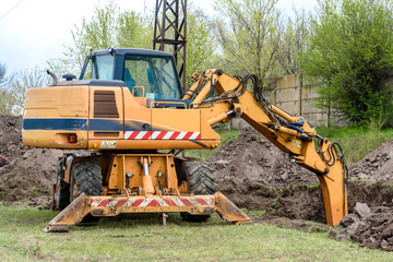 The modern excavator performs excavation work on the construction site