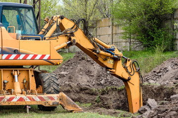 Fototapeta premium The modern excavator performs excavation work on the construction site