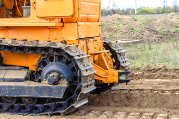 Industrial building construction site bulldozer leveling and moving soil during highway building