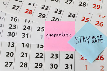 CORONAVIRUS. A sticker with the word quarantine on the calendar sheets. The concept of quarantine. Selective focus.
