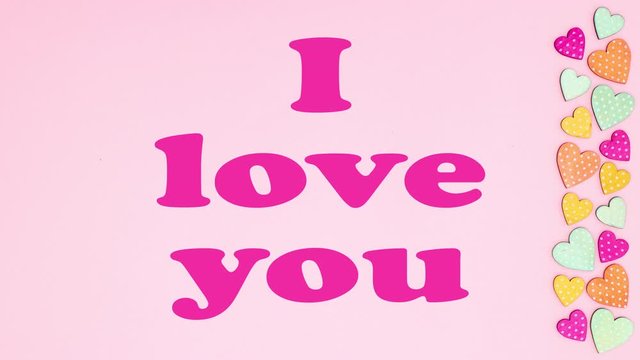 I love you title appear on pink background with hearts - Stop motion 