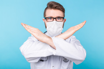 Medical male doctor wear a mask to prevent coronavirus 2019 and standing and raising hand to show...