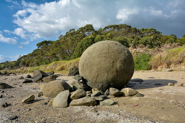 Lone round stones of Koutu Boulders on the beach, New Zealand
