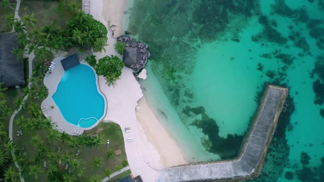 Aerial view of a beautiful resort right at the beach. Blue water swimming pool. Philippines, Asia