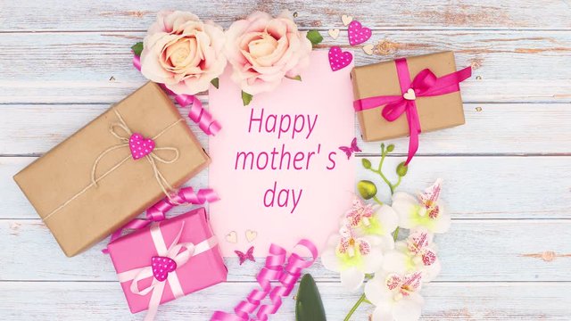 Happy mother's day - title appear on beautiful pink decoration with gifts and flowers - Stop motion 