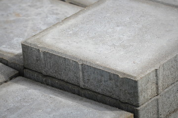 Stack of gray paving slabs. Laying the sidewalk of the tiles. Construction of sidewalks. Building...