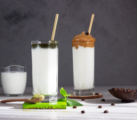 Dalgona coffee and matcha latte with mint, fluffy creamy whipped coffee with bamboo straws. Trend Korean coffee drink. 