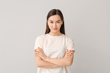 Obraz premium Portrait of beautiful young woman on grey background