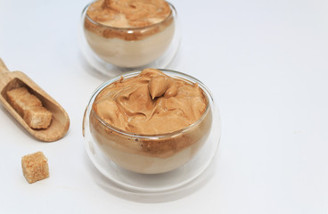 Dalgona coffee. Korean coffee in glasses cups on white bacground. Drink with milk, brown sugar and coffee.
