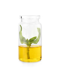 Bottle with basil essential oil on white background
