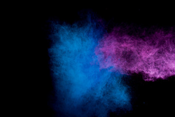 Colorful powder explosion on black background. Colorful dust explode. Paint Holi.