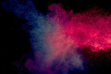 Naklejka na ściany i meble Colorful powder explosion on black background. Colorful dust explode. Paint Holi.