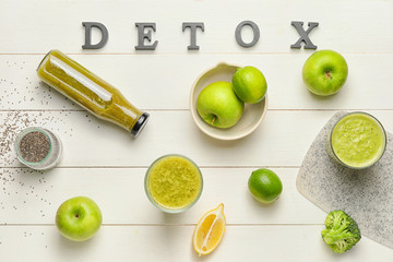Healthy smoothie with ingredients and word DETOX on table