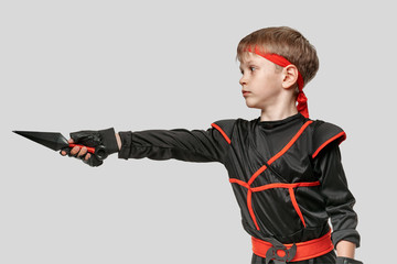 Portrait of young ninja boy training with kunai to attack the enemy © Denys Kurbatov