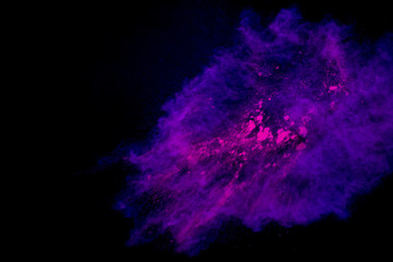 Colorful powder explosion on black background. Colorful dust explode. Paint Holi.
