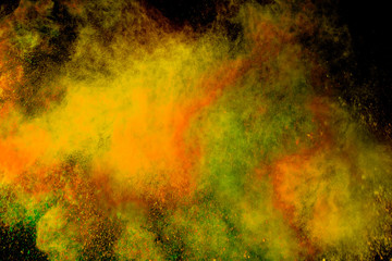 Colorful powder explosion on black background. Colorful dust explode. Paint Holi.