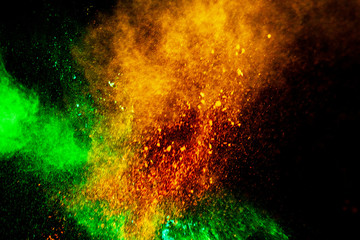 Colorful powder explosion on black background. Colorful dust explode. Paint Holi.