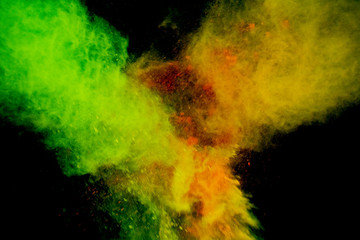 Colorful powder explosion on black background. Colorful dust explode. Paint Holi.