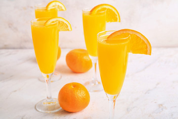Glasses of tasty mimosa cocktails on table