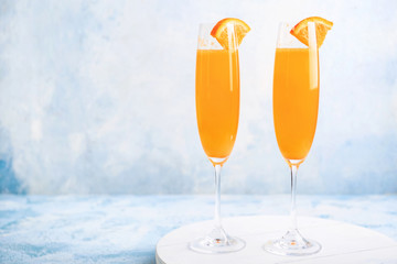 Glasses of tasty mimosa cocktails on table