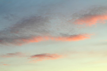 Clouds in the sky are illuminated from below by the red light of the sun. Sunset or sunrise scene...