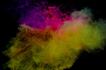 Naklejka na ściany i meble Colorful powder explosion on black background. Colorful dust explode. Paint Holi.