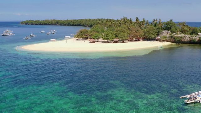 Small island white sand beach. Amazing resort with palm trees. Turquoise water. Philippines, Asia