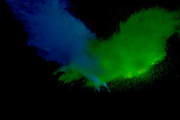 Obraz na płótnie Canvas Colorful powder explosion on black background. Colorful dust explode. Paint Holi.