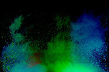 Colorful powder explosion on black background. Colorful dust explode. Paint Holi.