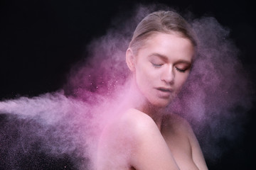 Beauty Products And Makeup Cosmetics. Beautiful Female Model Posing With Flying Pink Blush Powder On Face And Body. Fashionable Sexy Young Woman In Colored Cloud Of Cosmetic Powder. High Resolution