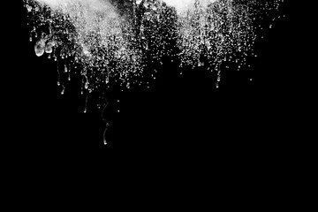 Abstract art powder paint on black background. Movement abstract frozen dust explosion multicolored on black background.