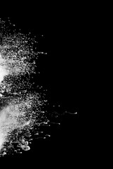 Abstract art powder paint on black background. Movement abstract frozen dust explosion multicolored on black background.