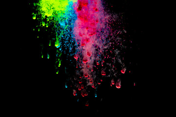 Abstract art powder paint on black background. Movement abstract frozen dust explosion multicolored on black background.