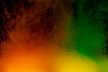 Abstract art powder paint on black background. Movement abstract frozen dust explosion multicolored on black background.