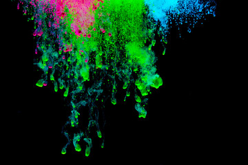 Abstract art powder paint on black background. Movement abstract frozen dust explosion multicolored on black background.