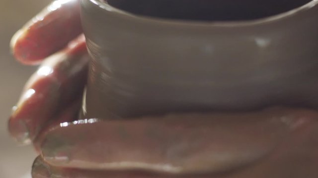 woman potter makes pitcher on a potter's wheel 4k