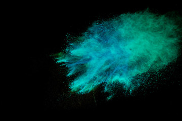 Colorful powder explosion on black background. Colorful dust explode. Paint Holi.