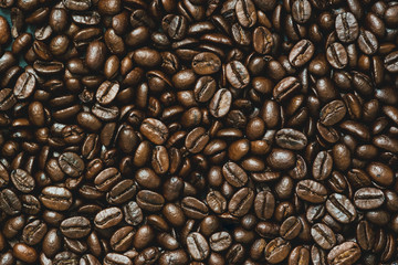 Top view of brown roasted coffee beans, can be use as background, copy space for text.