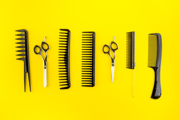 Hairdresser tools. Flat lay on yellow background top view