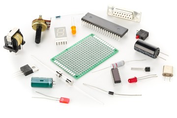 Different electronic parts or components on white with resistors, capacitors, diode and ic chips