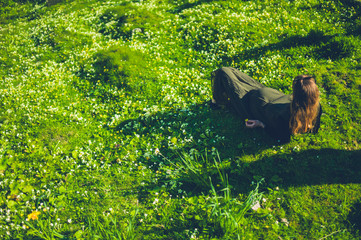 Pregnant woman lying in meadow