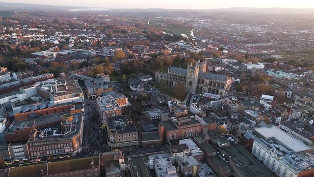 Busy Exeter city centre aerial. Fair in town on the cathedral green. lots of shoppers and pedestrians on the streets
