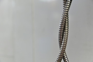 Close-Up of Armored Cable Against Blurred Background.