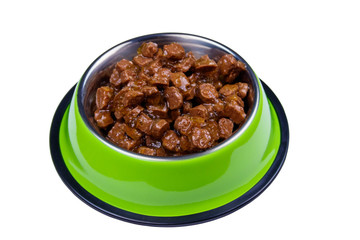 Canned food for cats or dogs in metal green bowl isolated on white background