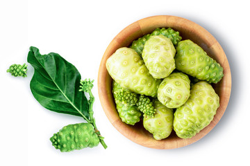 Fresh noni fruit ( morinda citrifolia indian mulberry, cheese fruit ) in wood bowl with green leaf isolated on white background. Top view. Flat lay.