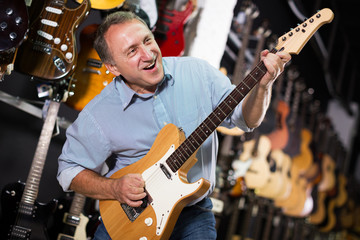 Male is playing on electric guitar