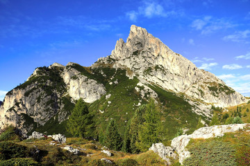 Beautiful Dolomites in Italy. Clear day with blue sky. Mountains are illuminated by the rays of the sun. Clean fresh air. Selective focus.