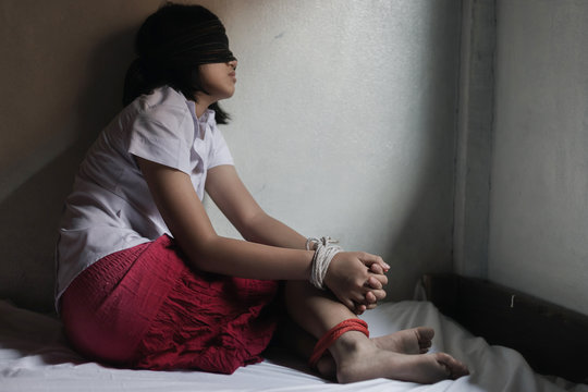 Kidnapped Young Girl Tied With Rope.Human Trafficking Concept. Stop Violence Against Women.