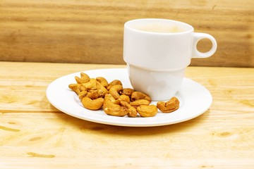 The cashew tree is a tropical evergreen tree that produces the cashew seed and the cashew apple. The tree can grow as high as 14 m, but the dwarf cashew, growing up to 6 m, has proved more profitable,