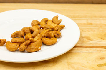 The cashew tree is a tropical evergreen tree that produces the cashew seed and the cashew apple. The tree can grow as high as 14 m, but the dwarf cashew, growing up to 6 m, has proved more profitable,
